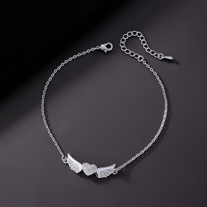 Tobillera Corazón Alas de Ángel con Circones Blancos. Acero Titanio Chapado Oro 18K